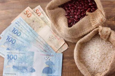 Rio de Janeiro, Brazil – September 7, 2020: basic food from brazil, rice and beans, next to a hundred reais bill, currency of brazil