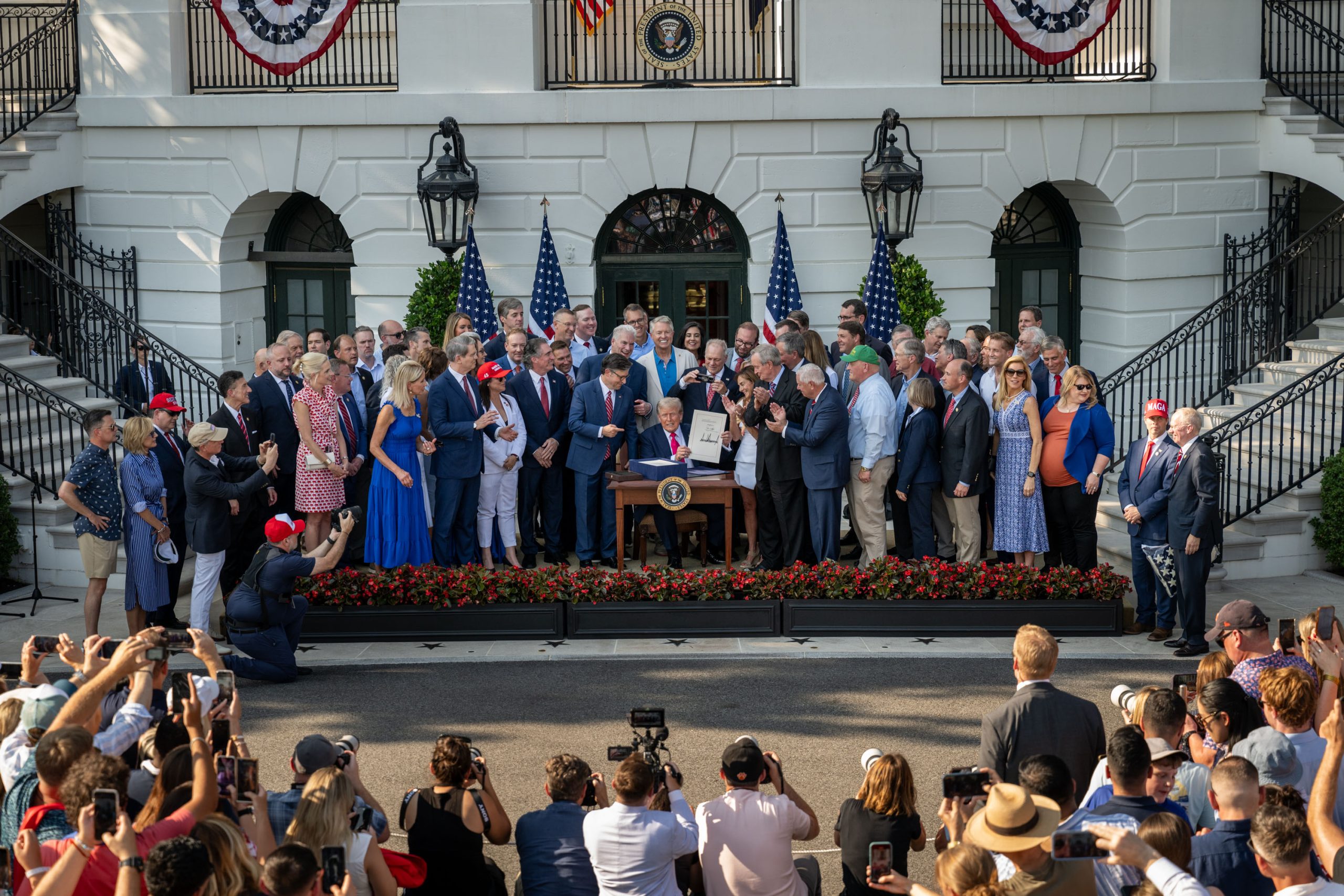 President Donald Trump signs the One Big Beautiful Bill Act on the South Lawn of the White House, Friday, July 4, 2025, during the 4th of July picnic. (Official White House Photo by Molly Riley)